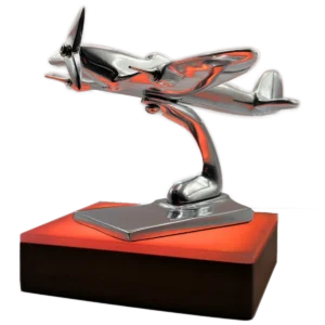 Polished aluminium Spitfire model on a wooden base glowing with orange light to show the aircraft is not currently flying
